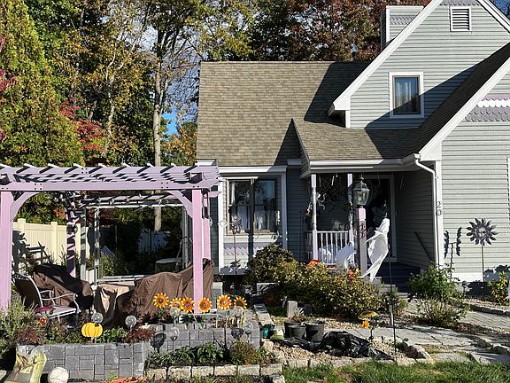 Front patio with pergulia, seating for 4 and 2 person swing. Fire ring. Great place to watch sunsets or children playing in cul-de-sac.