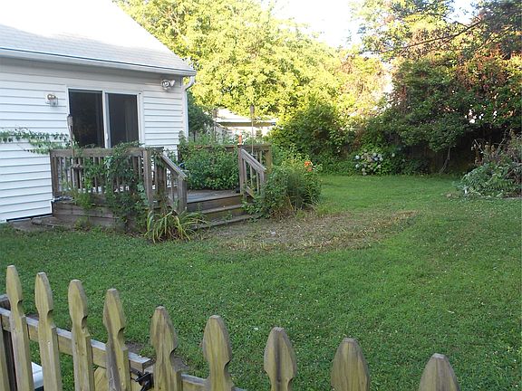Fenced in yard with shed