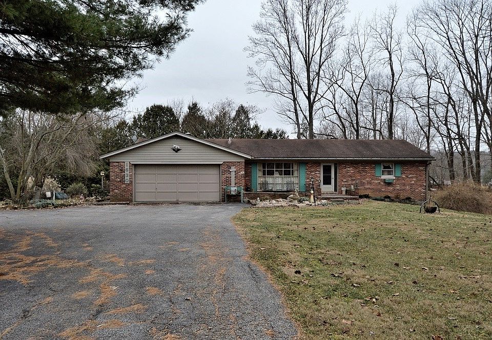 Black top drive Home sits of road for privacy