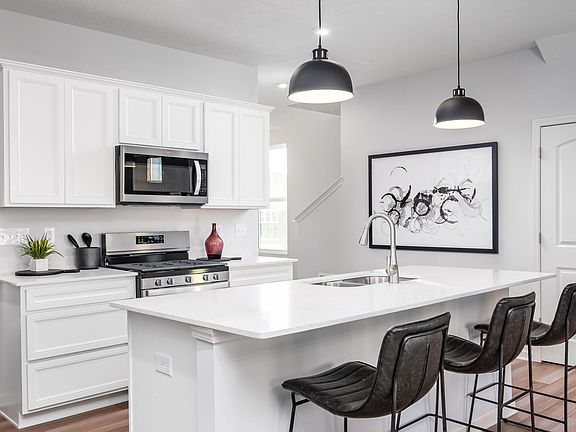 Spacious island overlooking the kitchen .Model home pic for illustrative purposes only. The actual home has a dark brown cabinet, Pics will be uploaded soon.