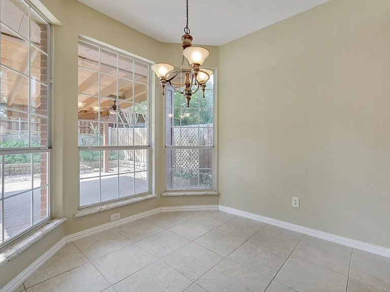 Breakfast area overlooking the covered patio, landscaping and back yard