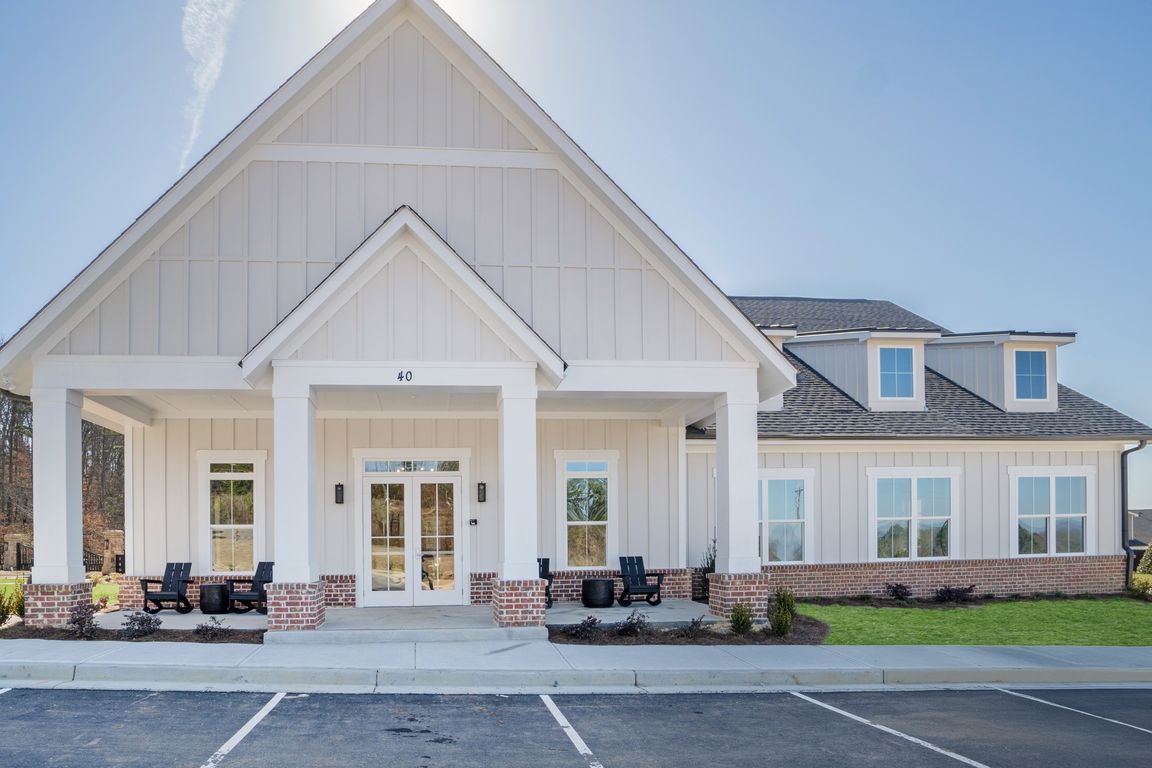 Clubhouse exterior with ample parking for future residents and visitors.