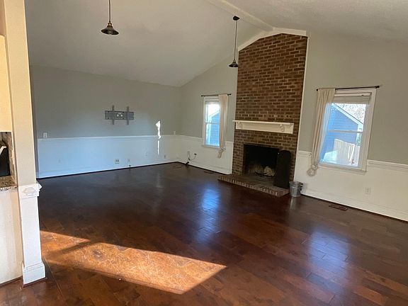 Great room w/ vaulted ceiling and wood burning fireplace