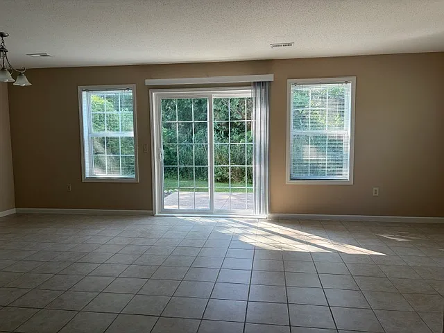 Airy and light filled open floor plan. Sliding door opens to patio and private rear yard
