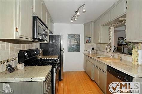 Kitchen remodeled with Colonial Gold Granite counter tops and Stone and glass tile back splash.