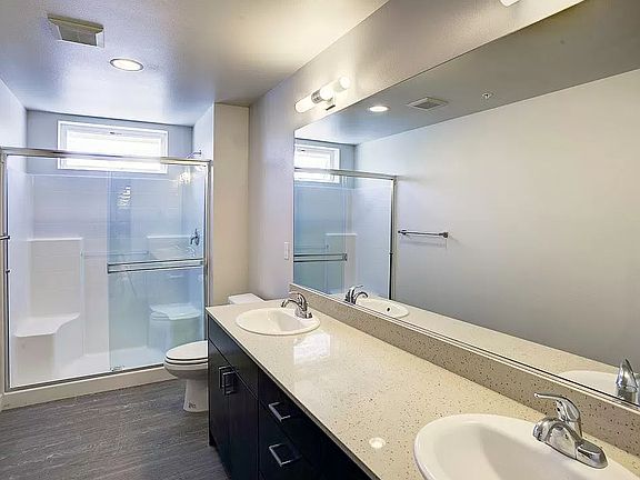 Bathroom features walk in shower and double sinks