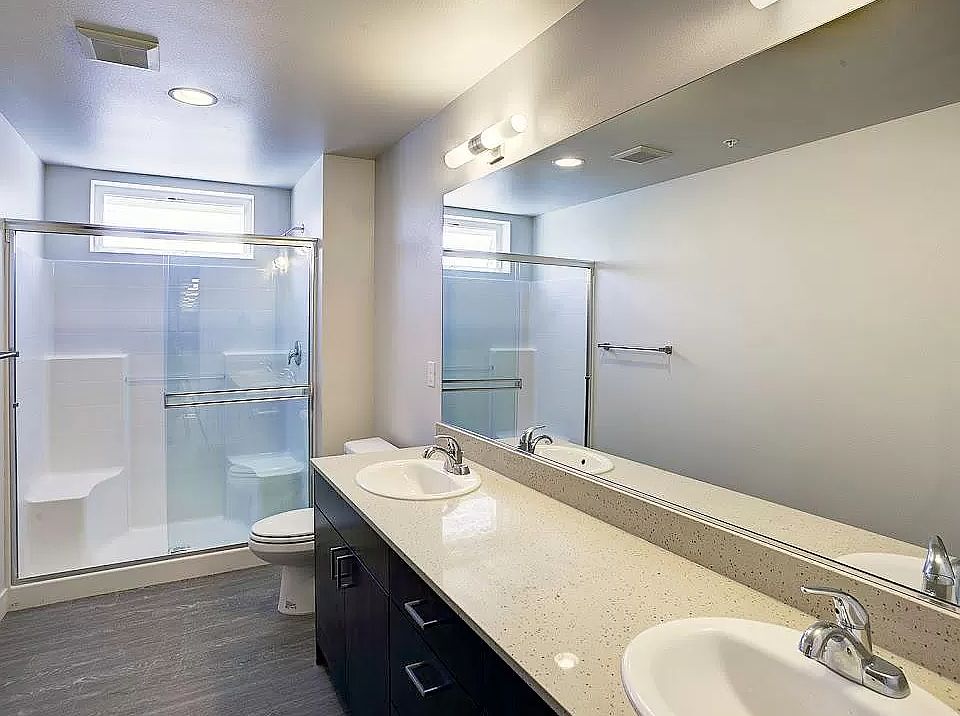 Bathroom features walk in shower and double sinks