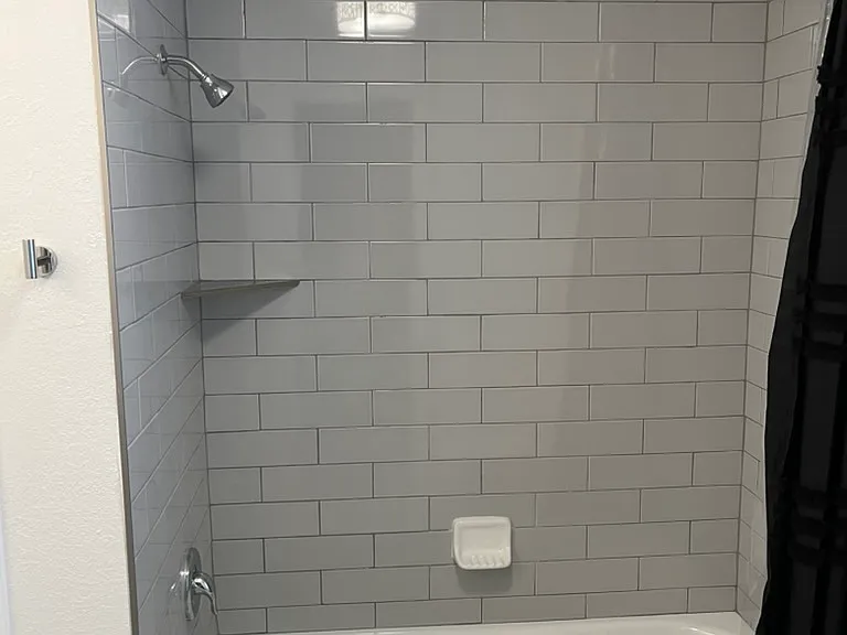 New tile in shower, new tub and all new fixtures.