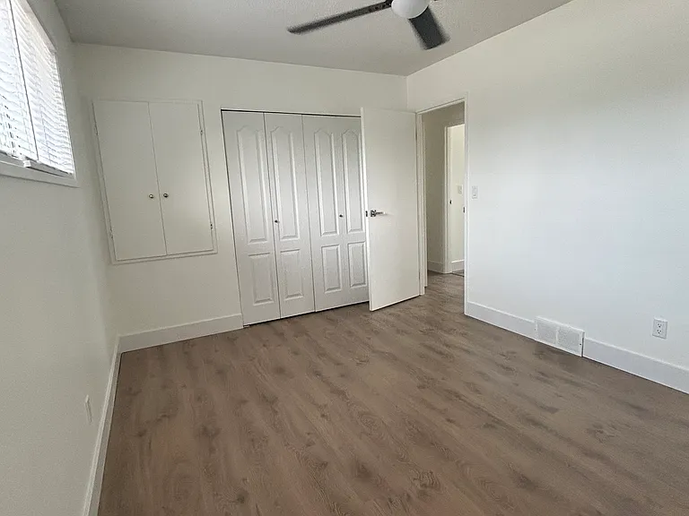 Primary bedroom with closet and storage cupboard