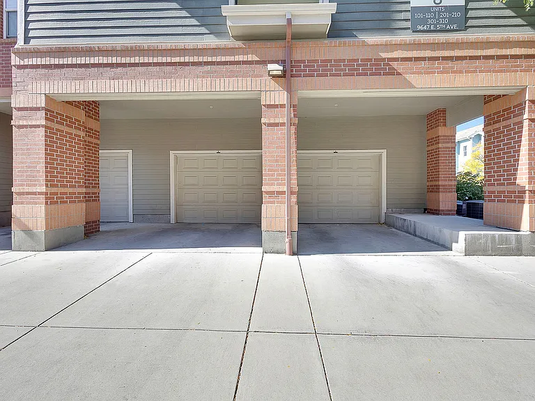 Spacious triple garage space with modern brick and siding exterior, perfect for multi-car families and ample storage.