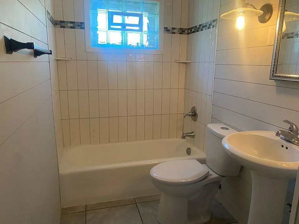 Step into a clean, bright bathroom with natural light and a full bathtub _ perfect for relaxing after a long day. Simple, functional, and designed for comfortable everyday living.