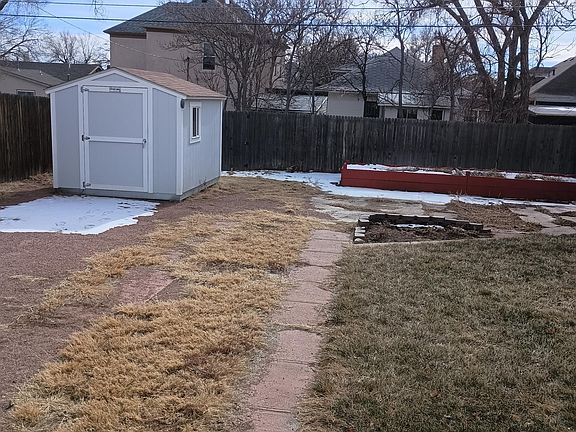Back yard: storage shed, garden beds, 6 ft privacy fence on all sides.