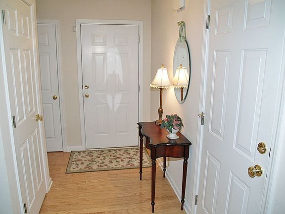 The open foyer is bright and spacious with shiny hardwood floors.