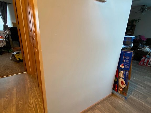 View of main level bedroom and hall to kitchen