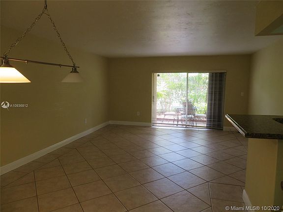 View as you enter from the main door looking across living/dining room to the patio beyond