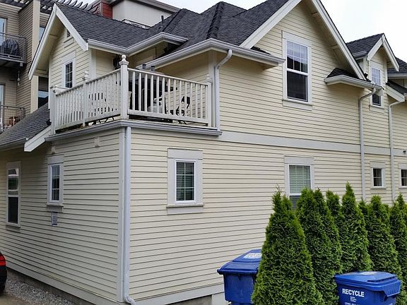 Duplex from alley showing unit's private deck