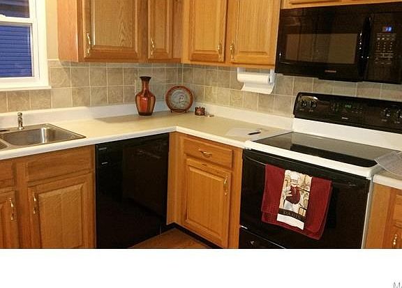 Kitchen has lots of counterspace, smooth top stove, new microwave, and custom tile backsplash.