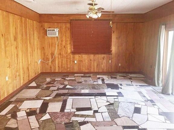 Huge 16'x25' family room/den with 12' sliding doors leading to a beautiful pool and grassy fenced-in yard. Beautiful and low-maintenance slate floors.