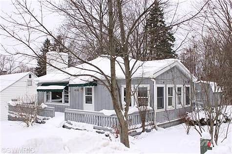 Well Built home on corner lot, with large deck across front of home.