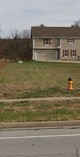 5129 Woodland Dr - Sits FAR back from street. Huge front and rear yards. Private parking for 6 vehicles!