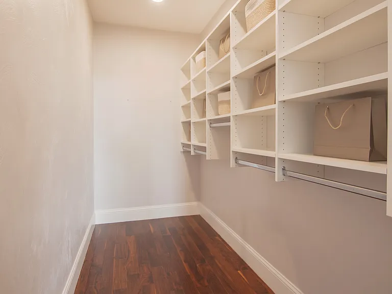 Primary bedroom walk-in closet