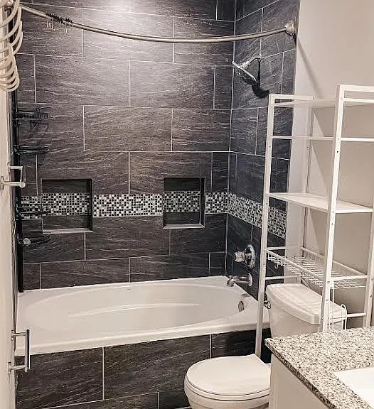 master bathroom - large deep soaker tub, over-toilet shelving, towel racks, and robe hooks, plus medicine cabinet