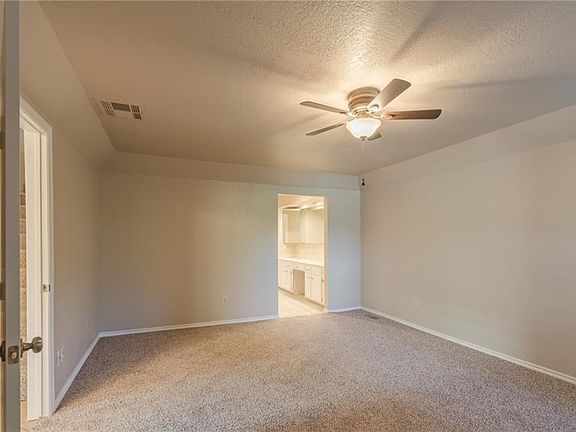 Master bedroom with nice ceiling fan, fresh paint, and new carpet.