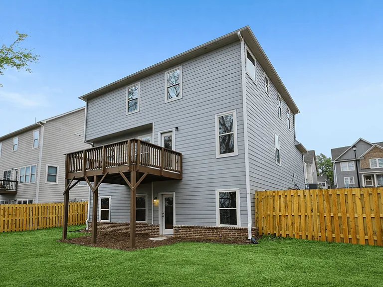 Scenic backyard and private deck with ample space for outdoor living.