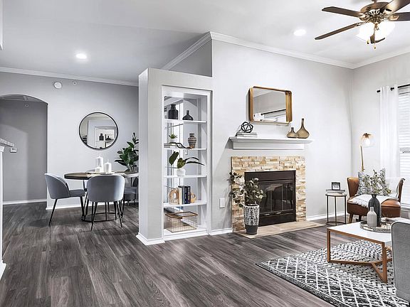 Built-In Shelves and Fireplace in Open-Concept Living and Dining Room
