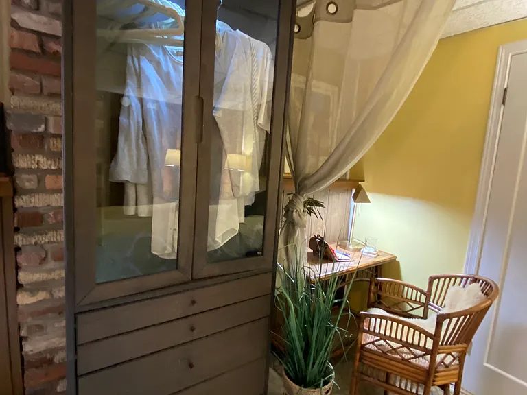 The brown hutch has been converted to a pseudo closet upper with drawers below.