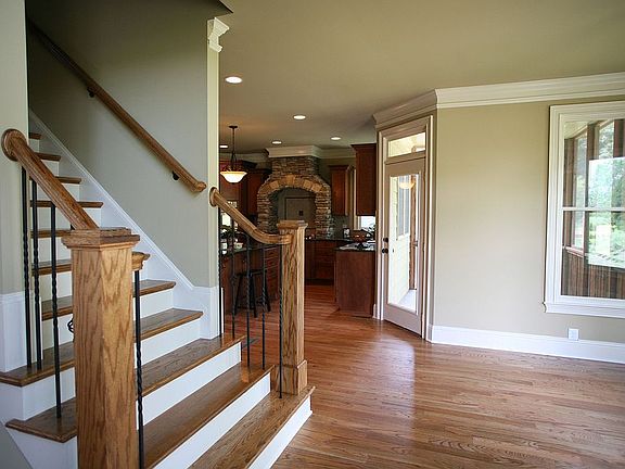 Stairs have hardwood treads and wrought iron spindles.