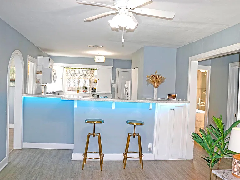 Brass stools & counter provide additional dining options.