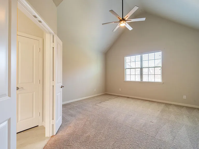Primary suite has soaring cathedral ceiling