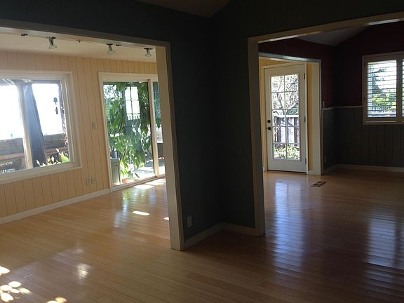 Looking from living room into dining room and family room and rear deck