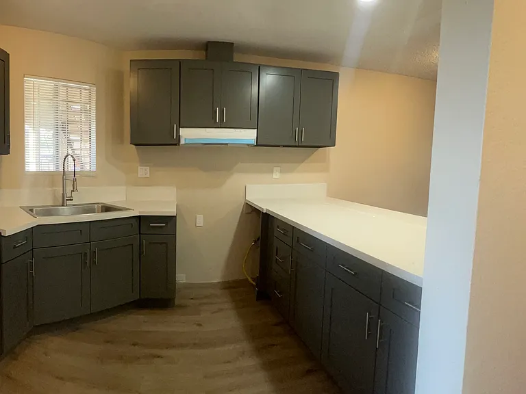 Enjoy a beautifully remodeled kitchen with modern finishes, a garbage disposal, and included appliances, including a stove and refrigerator (not pictured in the listing photos).