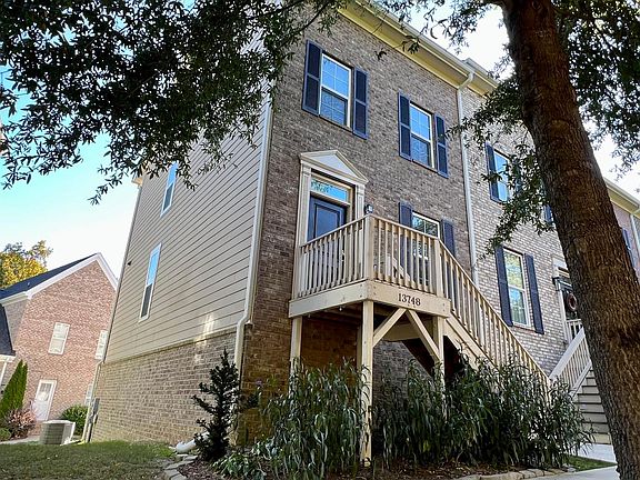 End unit with brick / hardboard siding
