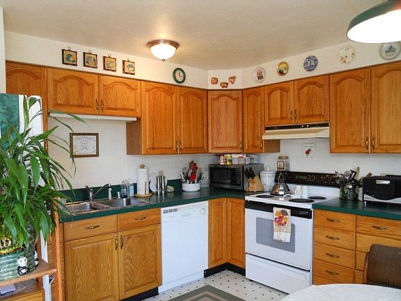 Light, bright kitchen features oak cabinets and the pantry is just around the corner.