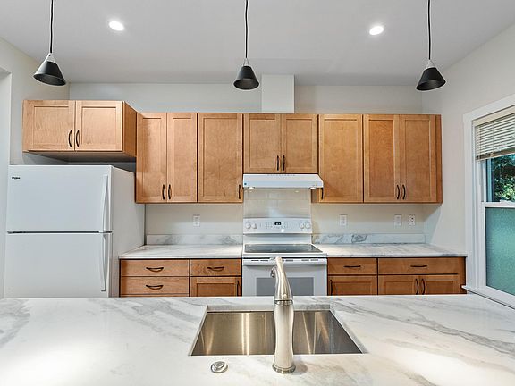 Kitchens feature cabinets in either warm maple or rich cherry. All new appliances, dishwasher and garbage disposal.