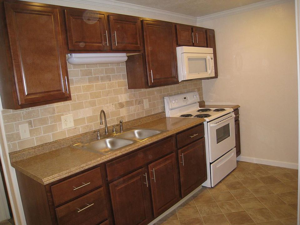 kitchen with microwave and range/oven and over the sink lighting