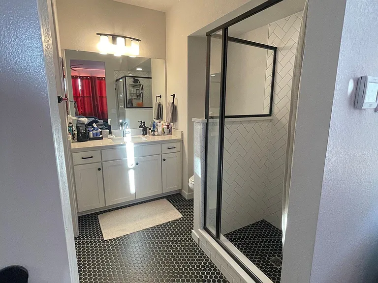 Barn door leads to master bathroom. Tall doors (9' ceilings).
Master bathroom with walk-in shower. Quartz countertop. Luxury height toilets.