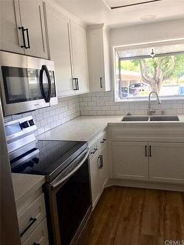 Upgraded kitchen, quartz counter, shaker cabinets, stainless steel appliances.