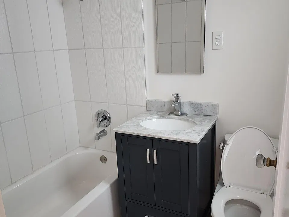 Bathroom with shower over tub