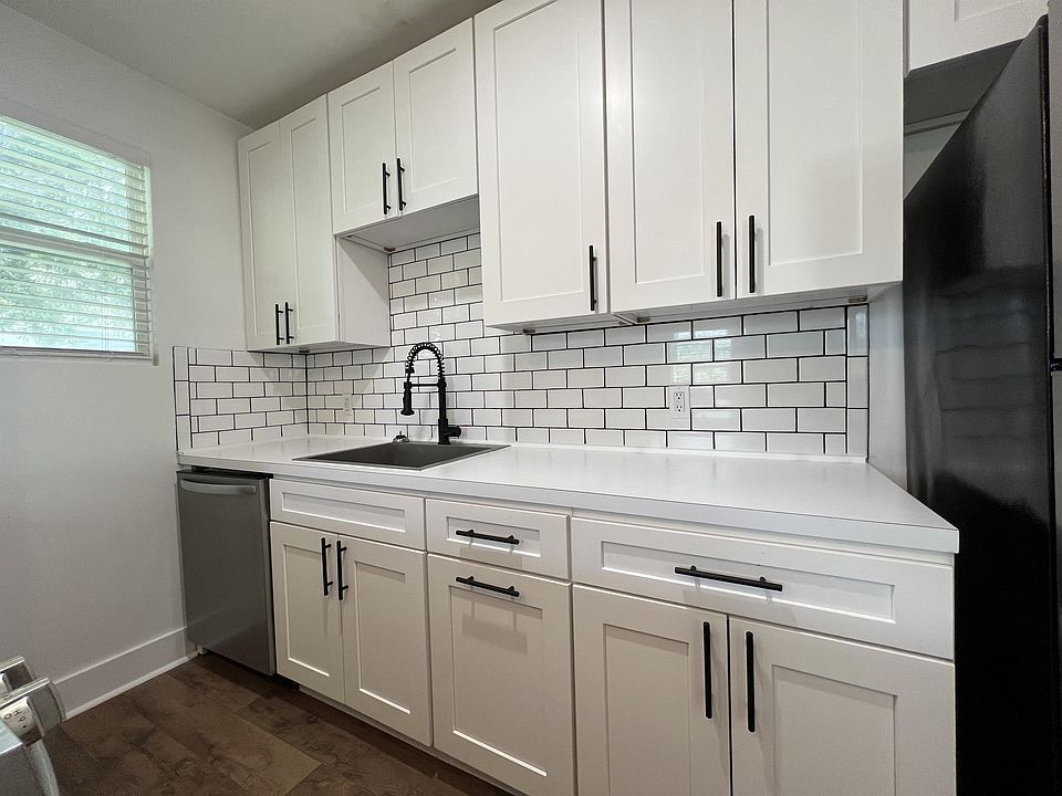 White Shaker kitchen cabinets, with slow close hinges, and white subway tile backsplash.