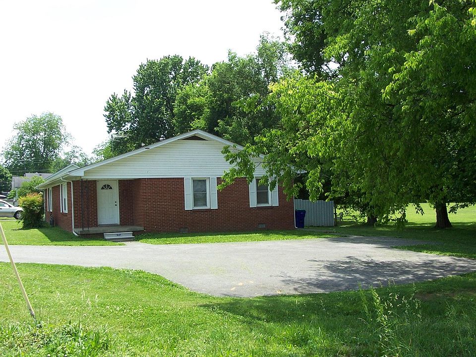 Front porch entrance. 
Back yard privacy fence seen at the right of house.