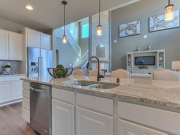 Kitchen island featuring granite countertops and optional pendant lighting.