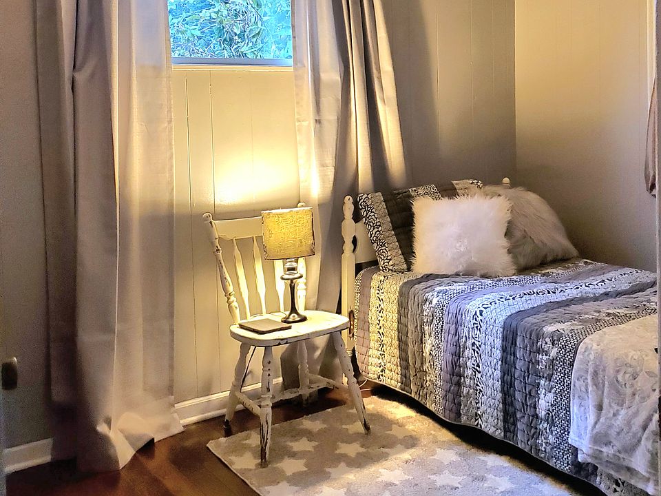 Smallest room located closest to bathroom and faces back yard. Bigger window at right of bed, faces back yard/raised garden.