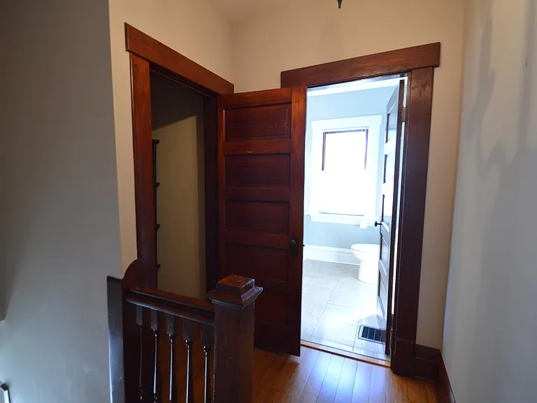 Hallway linen closet and large full bathroom.