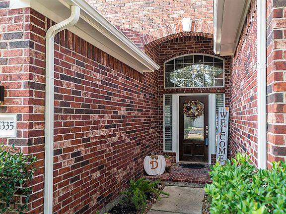 A sidewalk leads you to a charming arched covered front porch!