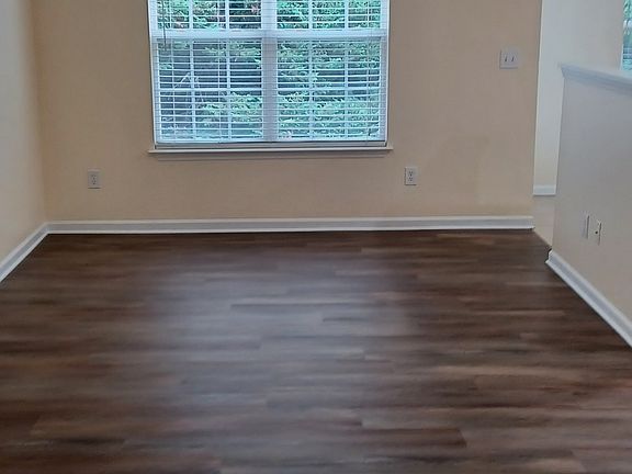 View from garage intrance to living room with new vinyl wood decor floor