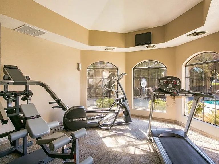 Fitness center with a pool view